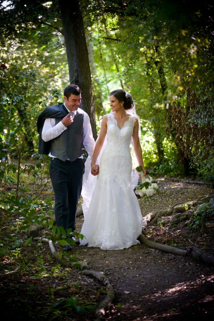 Bride and groom walking in garden