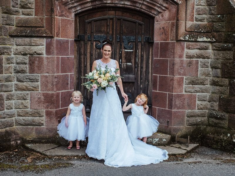 Bride with her bouquet and flower girls