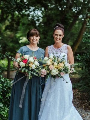 Bride and bridesmaid with their wedding flowers